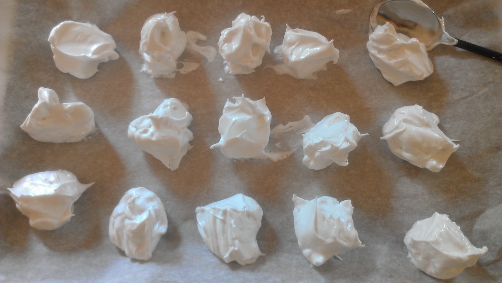 uncooked meringues on tray